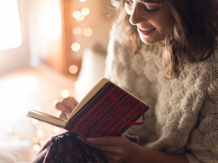 Smiling woman writing on her notebook