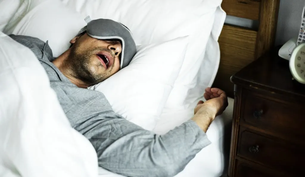 A man sleeping on a bed