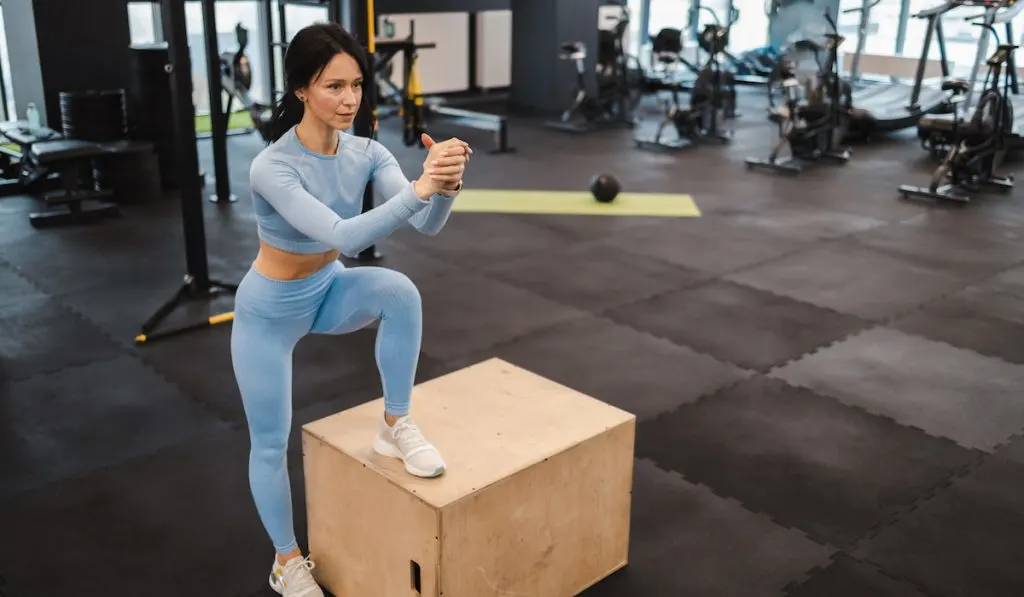 Athletic woman warming up on crossfit box