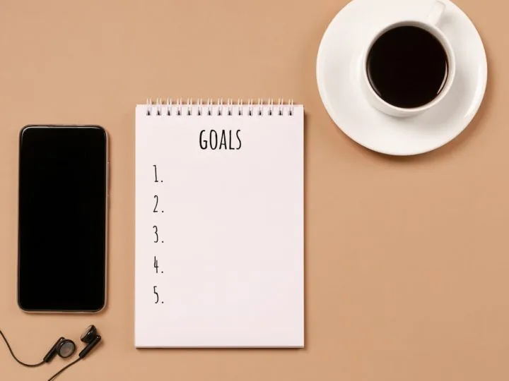 Blank-notepad-for-action-plans-goals-coffee-cup-phone-pastel-background
