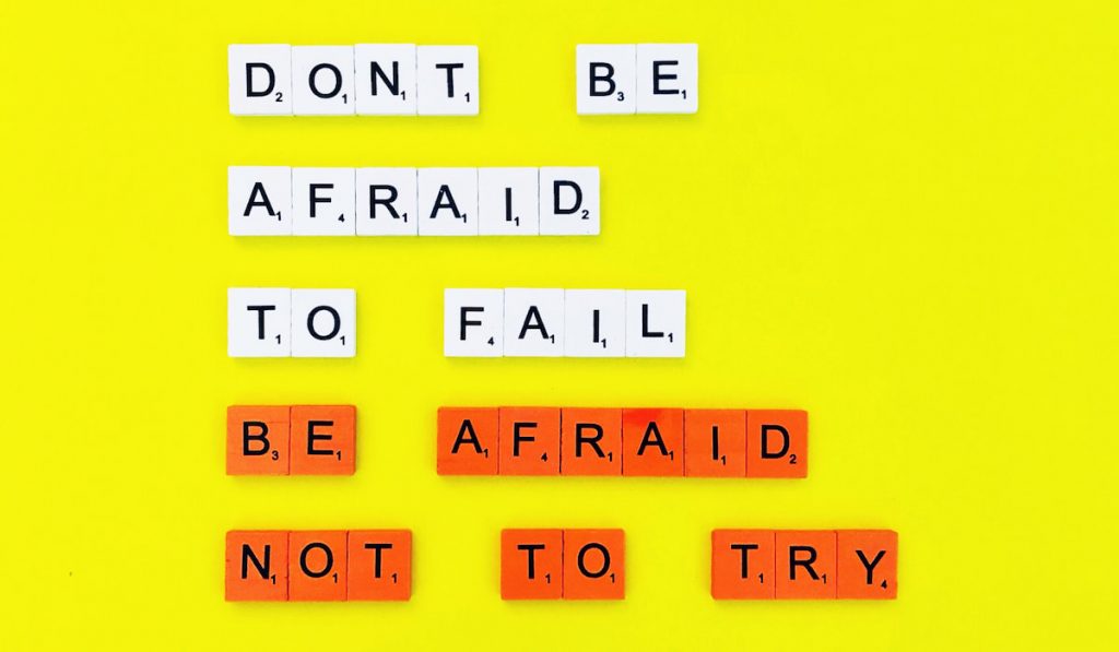 Don’t be afraid to fail. Be afraid not to try quote on yellow background 