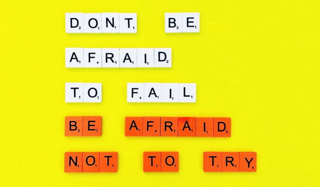 Don’t be afraid to fail. Be afraid not to try quote on yellow background