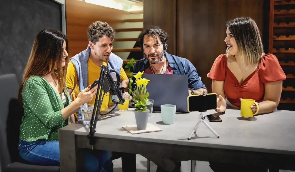 Influencers sitting around the table vlogging