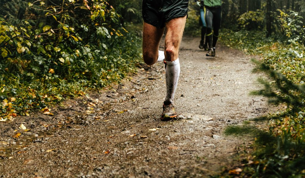 male runner runs on marathon and other runner on the back