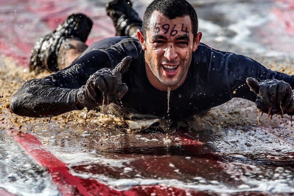 Mud run adventure man on the ground 