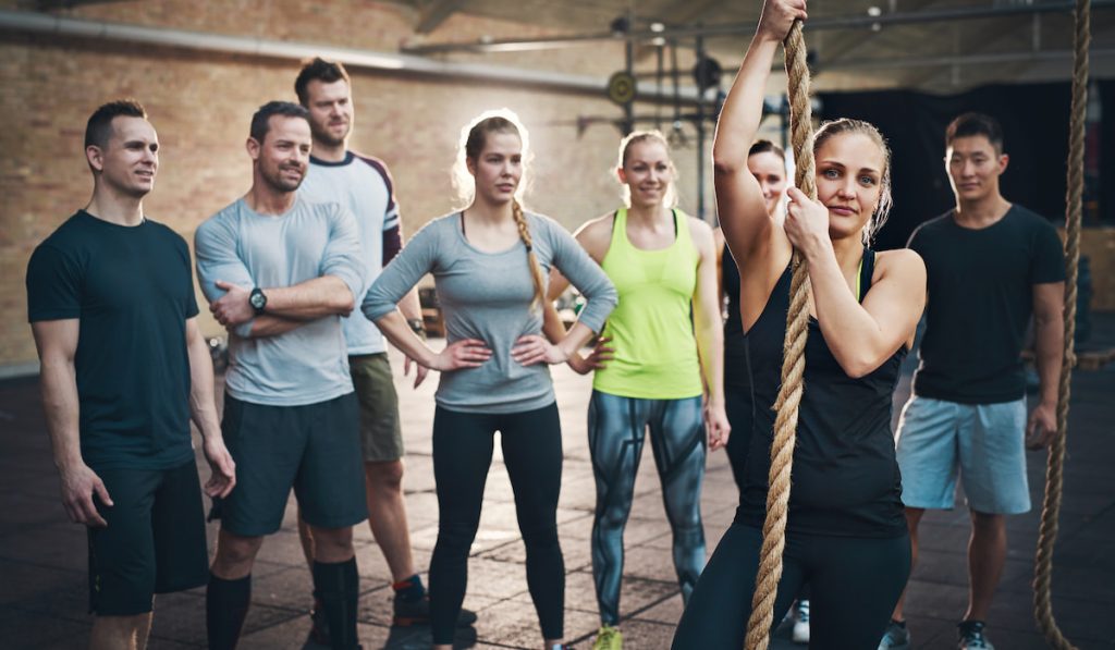 Woman holding climbing rope in cross-fit exercise