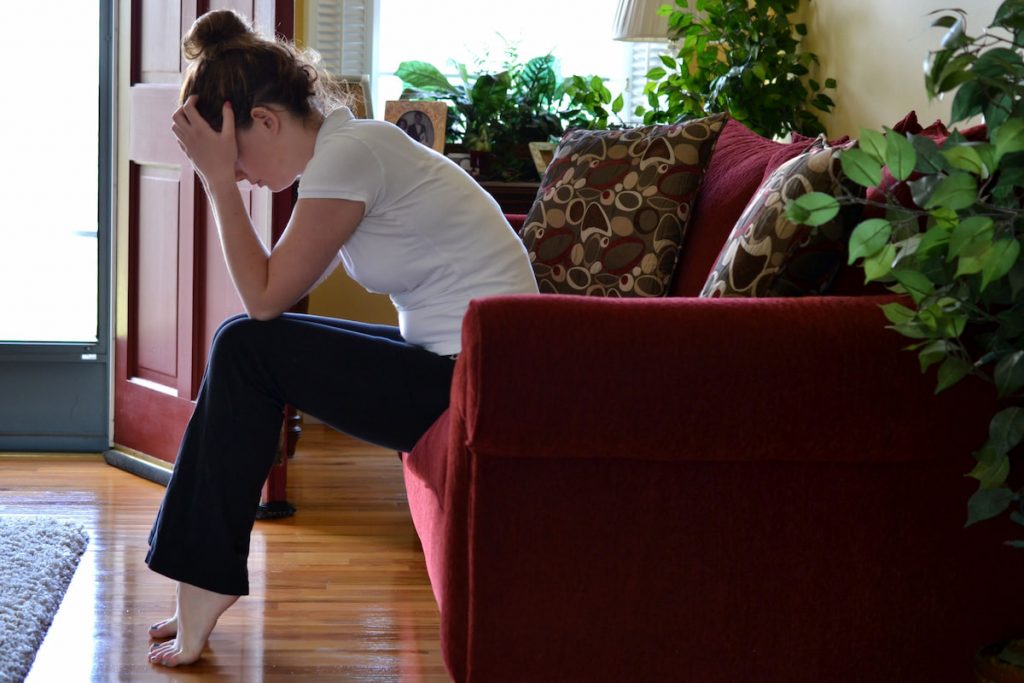 Young female with head in hands trying to cope. anxiety mental health