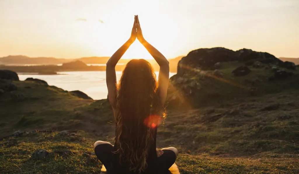 Young woman practicing yoga outdoors