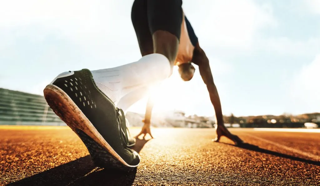 athlete getting ready to run outdoors