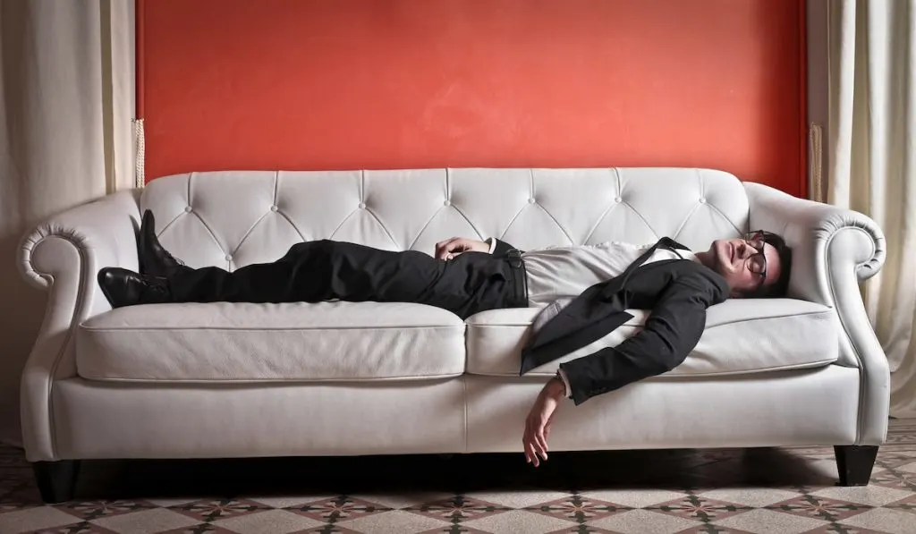 businessman sleeping on the couch dreaming
