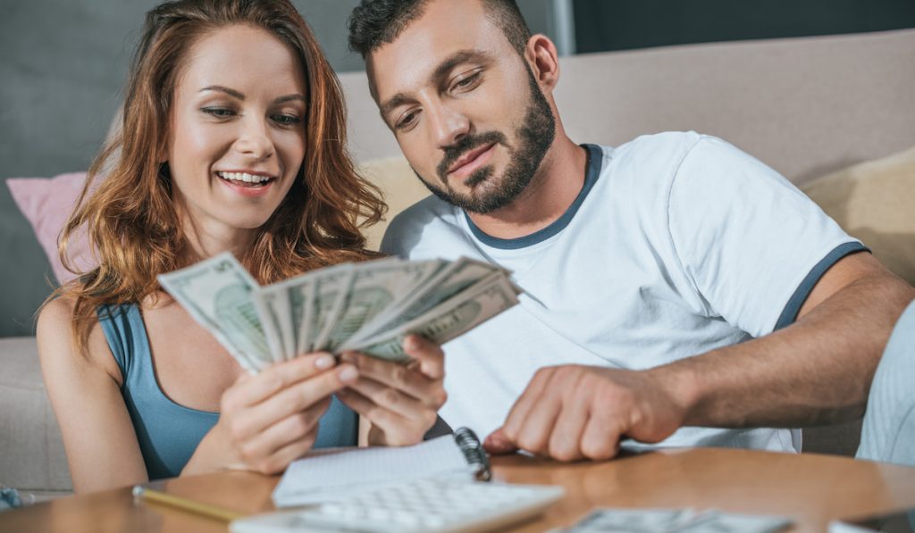 couple planning family budget in living room