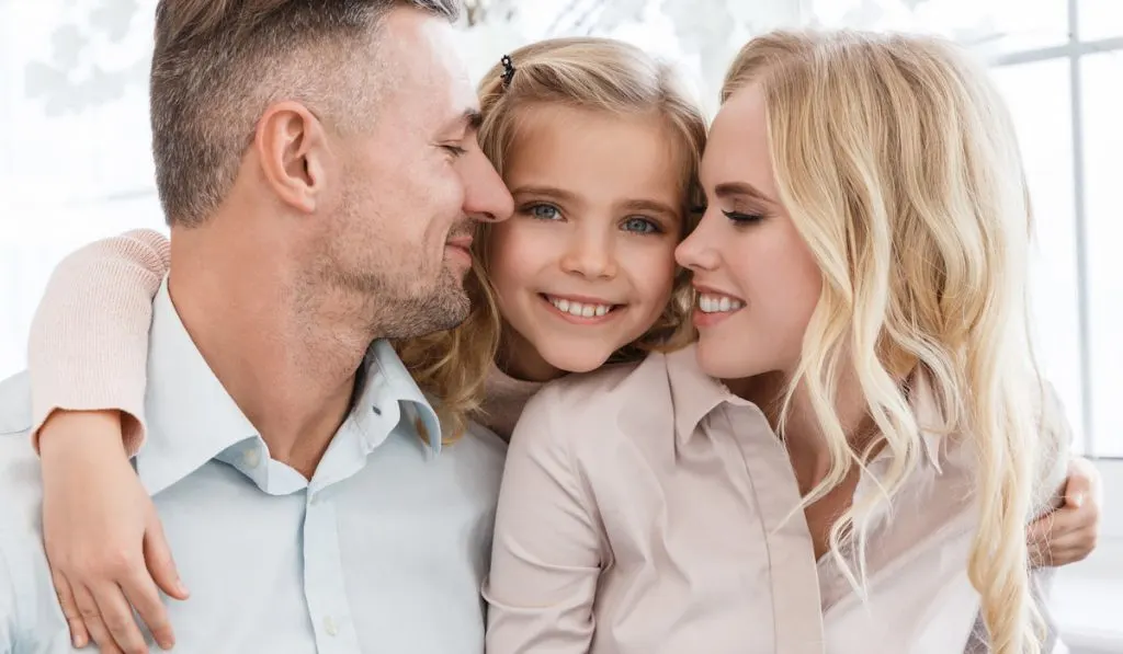 happy young family cuddling together