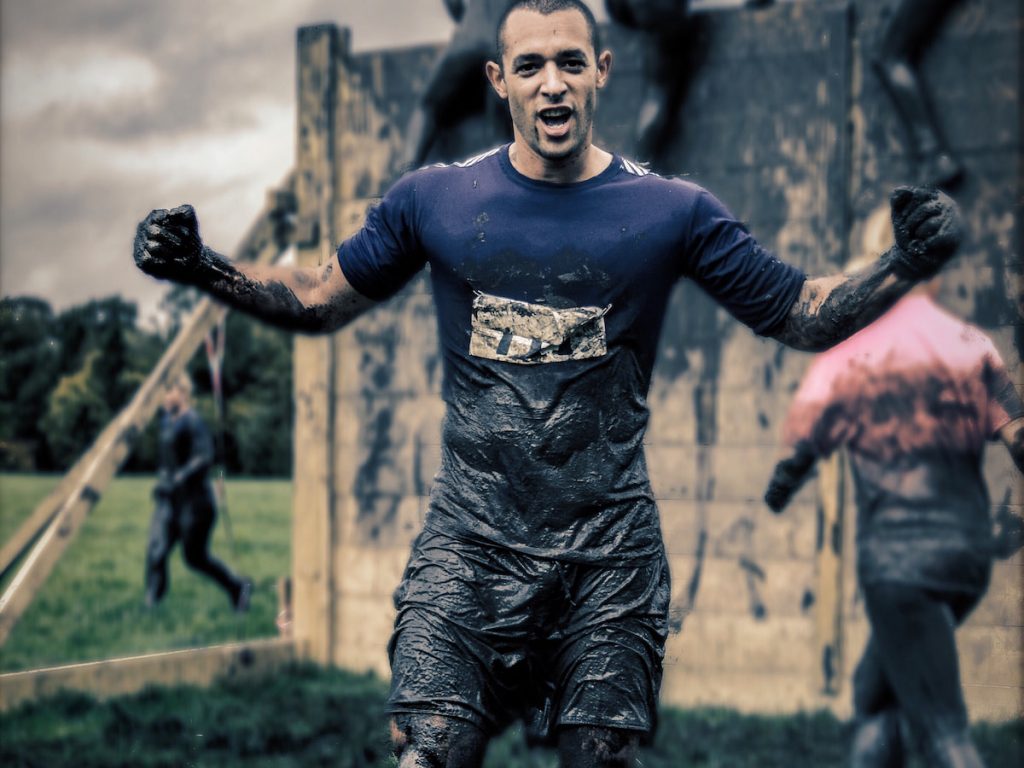 man proudly finished mud run