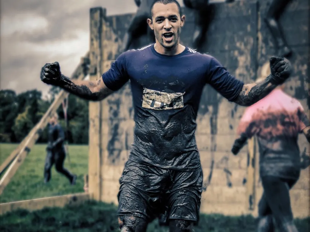 man proudly finished mud run