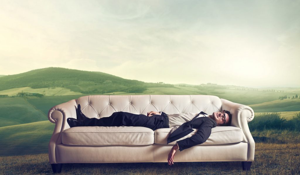 man sleeping on a couch and dreaming -