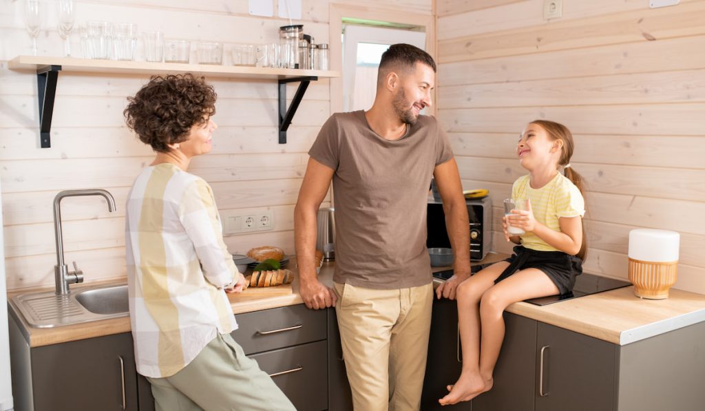 mother, father and daughter in casualwear discussing plans for the day