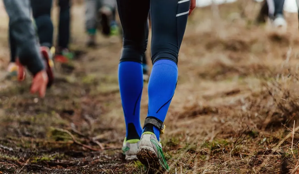 runner legs in compression socks while running