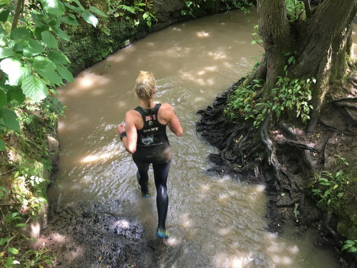 woman-running-on-forest-mud